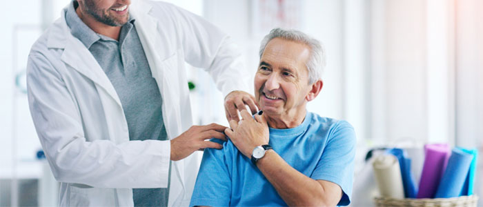 a photo with a doctor with his hand on a patients shoulder