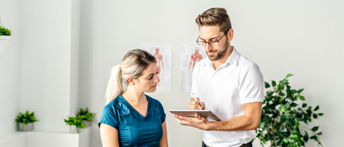 chiropractor evaluating a patient